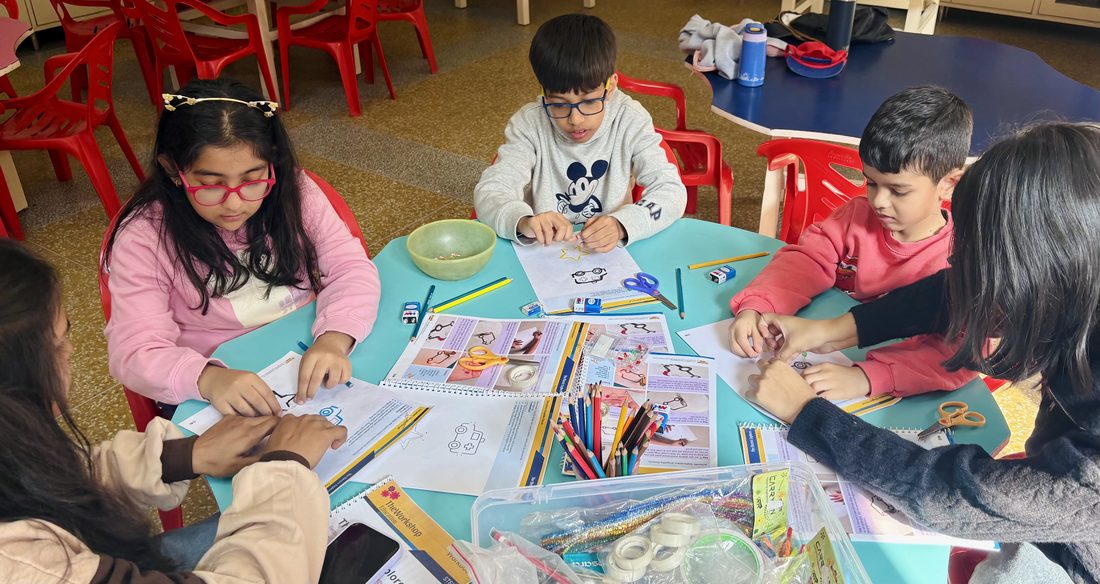 A group of children working together at a table during a craft activity.